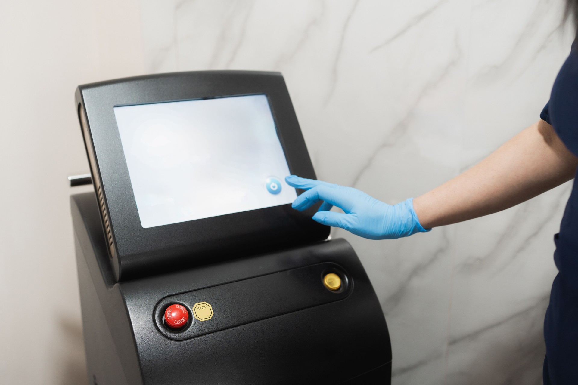 cosmetalogist performing Q Switch laser treatment